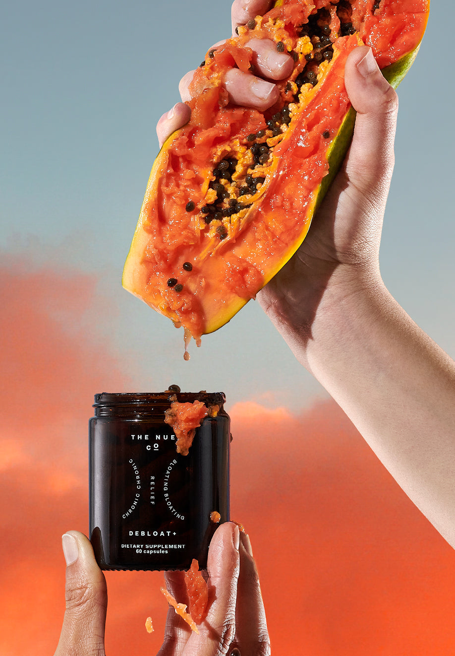 Papaya Pulp being squeezed into a bottle of DEBLOAT+ Capsules